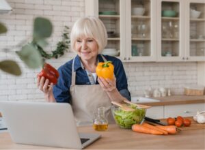 Older woman in kitchen learning about healthy eating